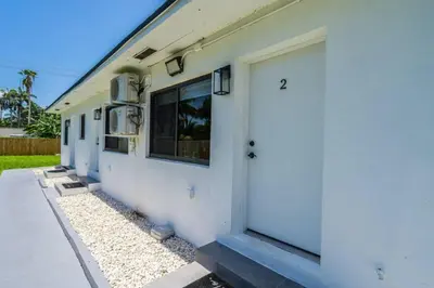a white building with a door and a window at Unit 2 Cute Studio in North Miami 10min to beach in Miami