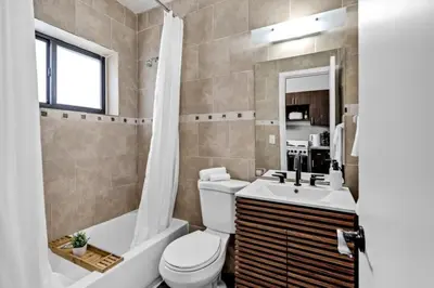 a bathroom with a toilet and a tub and a sink at Unit 2 Cute Studio in North Miami 10min to beach in Miami