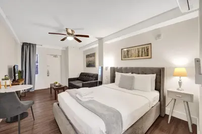 a bedroom with a large bed and a living room at Eden Collection Junior Suite Steps to Beach in Fort Lauderdale