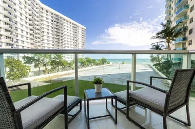 a balcony with chairs and a table and a view of the ocean at Beachfront Winter Escape, Balcony with Ocean View, Amenities in Hollywood