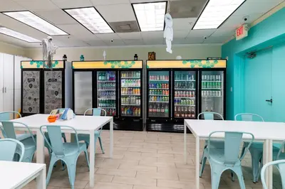 a restaurant with tables and chairs and refrigerators at Beachfront Winter Escape, Balcony with Ocean View, Amenities in Hollywood