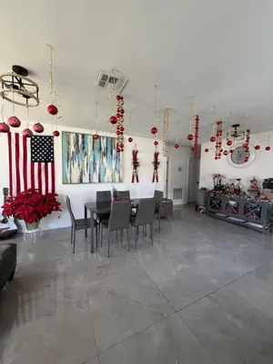 a room with a table and chairs and an american flag at USA Star Hostel in Hallandale Beach