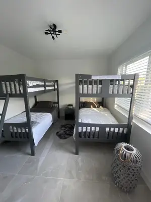 a bedroom with two bunk beds in a room at USA Star Hostel in Hallandale Beach
