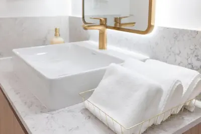 a white bathroom with a sink and a mirror at 4513 a 1-Bedroom Apt with Pool and Gym next to Kaseya Center in Miami