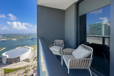 a balcony with two chairs and a view of a city at 4513 a 1-Bedroom Apt with Pool and Gym next to Kaseya Center in Miami