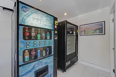 a vending machine with bottles of water in a room at Eden Collection Studio Steps to Beach in Fort Lauderdale