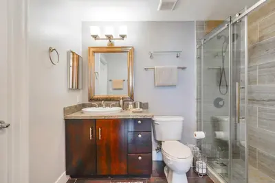 a bathroom with a toilet and a sink and a shower at Stylish Brickell Penthouse with Exclusive Perks in Miami