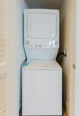 a microwave sitting on top of a washer and dryer at Lyfe Resort & Residences By OceanMiami in Hollywood