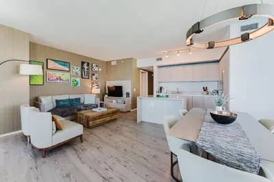 a kitchen and living room with a table and a couch at Lyfe Resort & Residences By OceanMiami in Hollywood