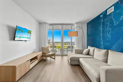 a living room with a couch and a table at Coastal Luxe Residences - Premium Suites with Pool and Water Views in Hallandale Beach