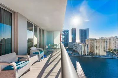 a balcony of a building with a view of the city at Coastal Luxe Residences - Premium Suites with Pool and Water Views in Hallandale Beach