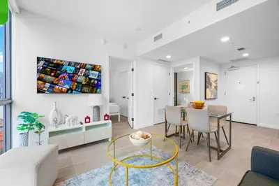 a living room with a table and a dining room at Modern Comfort by the Beautiful Bay in Miami