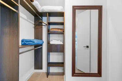 a walk in closet with a mirror and bunk beds at Modern Comfort by the Beautiful Bay in Miami