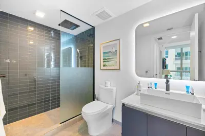 a bathroom with a toilet and a sink and a shower at Modern Comfort by the Beautiful Bay in Miami