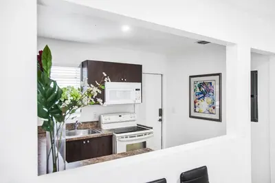 a white kitchen with a sink and a stove at Buena Vista-Miami Designer Apartment # 3 in Miami