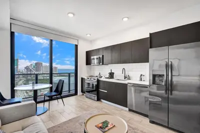 a kitchen with stainless steel appliances and a large window at Lux Studio Miami and Bay views in Miami