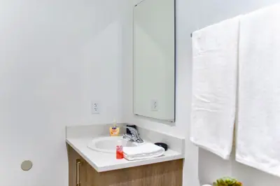 a bathroom with a sink and a mirror at Family-Friendly Townhouse Getaway Near Top Attractions in Golden Glades