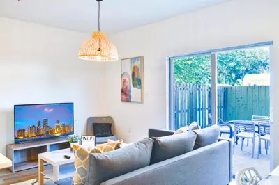 a living room with a couch and a table at Family-Friendly Townhouse Getaway Near Top Attractions in Golden Glades