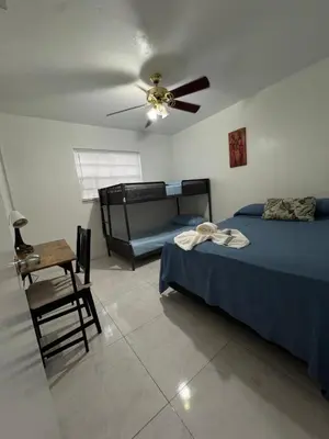 a bedroom with two beds and a ceiling fan at Layover Miami International Airport in Miami