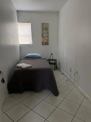 a bedroom with a bed in a white room at Layover Miami International Airport in Miami