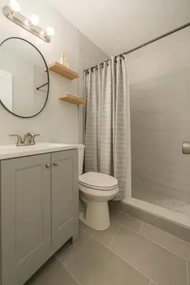 a bathroom with a toilet and a sink and a mirror at Layover Miami International Airport in Miami