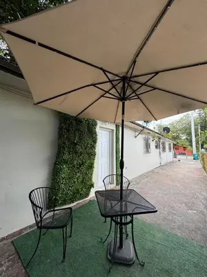 a table and two chairs under an umbrella at Layover Miami International Airport in Miami