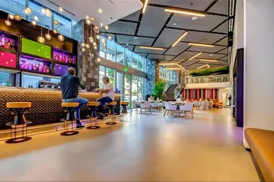 two people sitting at a bar in a restaurant at Downtown Large Stylish 1 bedroom condo Gym pool in Miami