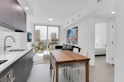 a kitchen and dining room with a table and a bed at Downtown Large Stylish 1 bedroom condo Gym pool in Miami
