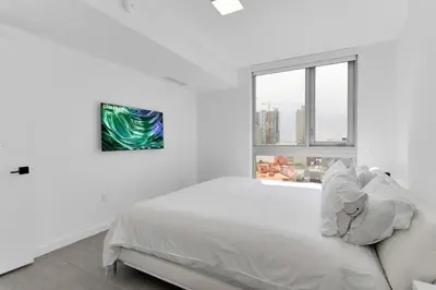 a white bedroom with a bed and a window at Downtown Large Stylish 1 bedroom condo Gym pool in Miami