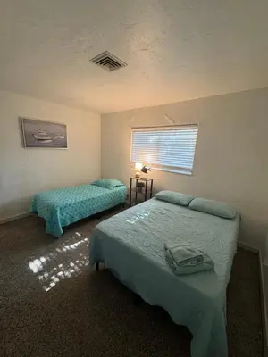 a bedroom with two beds and a window at La Mare Fort Lauderdale Airport in Fort Lauderdale
