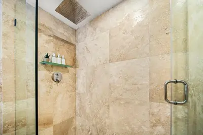 a bathroom with a shower with a glass door at Studio Residence at Roney -1128 in Miami Beach