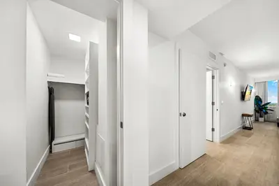 an apartment hallway with white walls and a staircase at Studio Residence at Roney -1128 in Miami Beach