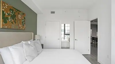 a bedroom with a white bed with white pillows at The Juliet V Vibe 8700 in Miami