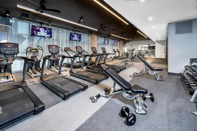 a gym with a bunch of exercise bikes and treadmills at The Juliet VI Vibe 8701 in Miami