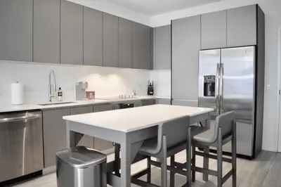 a kitchen with a table and chairs and a refrigerator at The Juliet VI Vibe 8701 in Miami