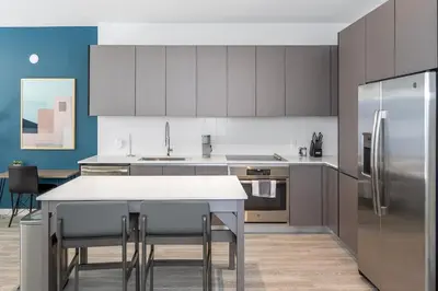 a kitchen with a refrigerator and a table with chairs at The Juliet VII Vibe 8702 in Miami