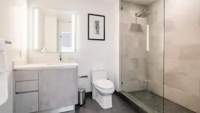 a bathroom with a toilet and a sink and a shower at The Juliet IX Vibe 8707 in Miami