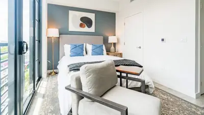 a bedroom with a bed and a chair and a window at The Juliet IX Vibe 8707 in Miami