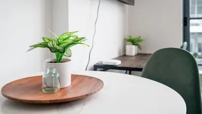 a wooden tray with a glass bottle on a table with a plant at The Juliet IX Vibe 8707 in Miami