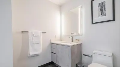 a bathroom with a sink and a toilet and a mirror at The Juliet IX Vibe 8707 in Miami