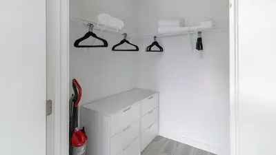 a kitchen with white cabinets and black hangers at The Juliet X Vibe 8741 in Miami