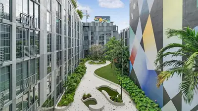 an internal courtyard of a building with trees and plants at The Juliet X Vibe 8741 in Miami