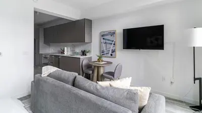 a living room with a couch and a kitchen at The Juliet X Vibe 8741 in Miami