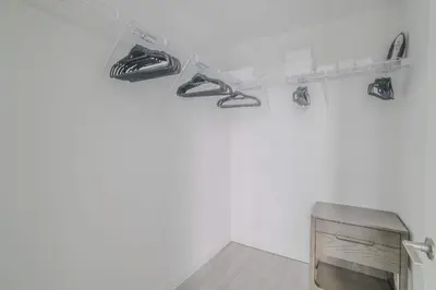 a room with a tv and shoes on a shelf at The Juliet XI Vibe 8744 in Miami