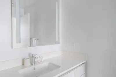a white bathroom with a sink and a mirror at The Juliet XI Vibe 8744 in Miami