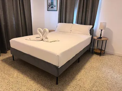 a bed with a pair of shoes on top of it at Wynwood Bungalows By Renzzi in Miami