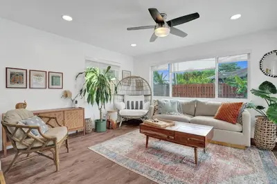 a living room with a couch and a table at Newly Renovated w Heated Saltwater Pool & Hot Tub in Hollywood