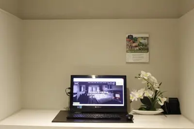 a laptop computer sitting on top of a desk at San Juan Hotel Miami Beach in Miami Beach