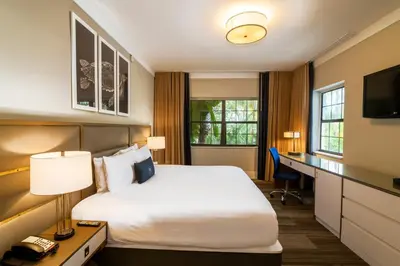 a hotel room with a bed and a desk at San Juan Hotel Miami Beach in Miami Beach
