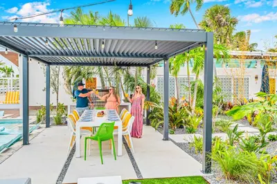 a family standing under a pergola on a patio at Waterfront Heated pool Lime Key Two in Fort Lauderdale